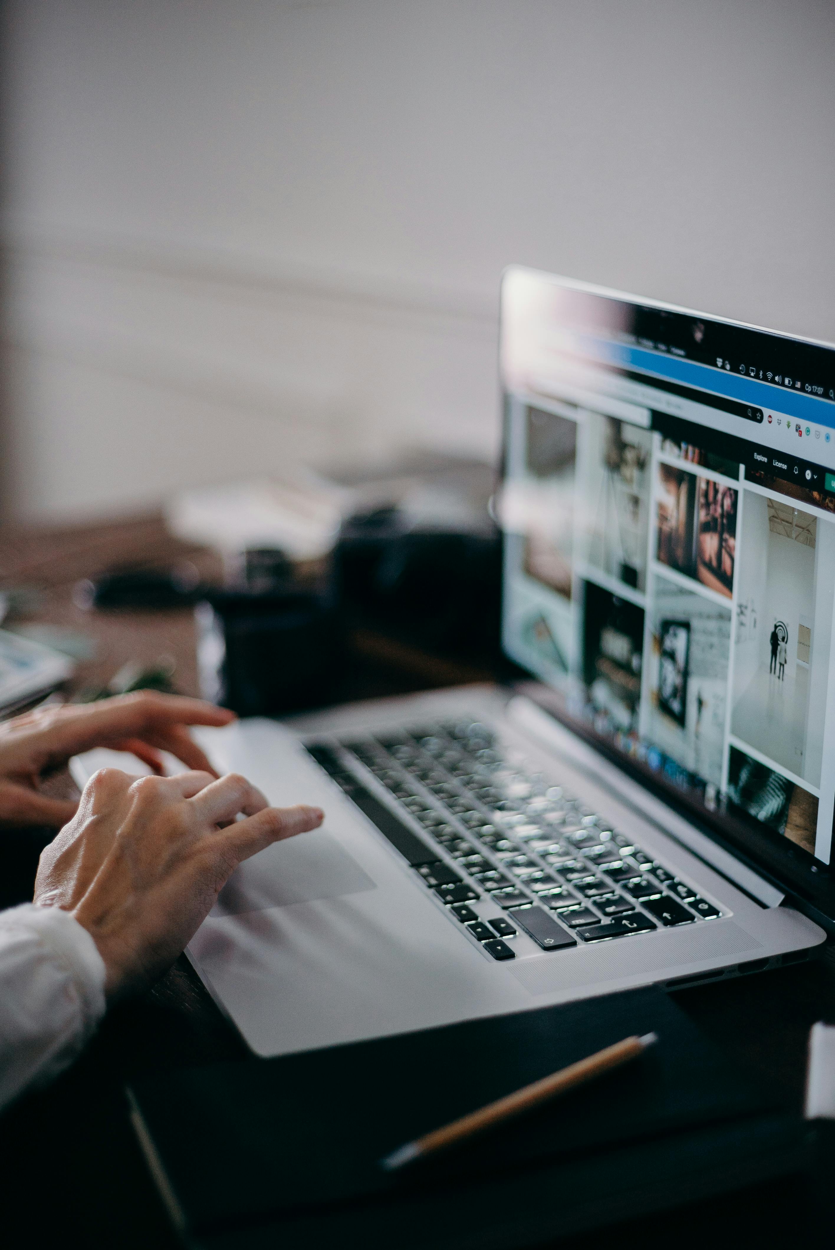 Picture of hands moving the mouse on a laptop